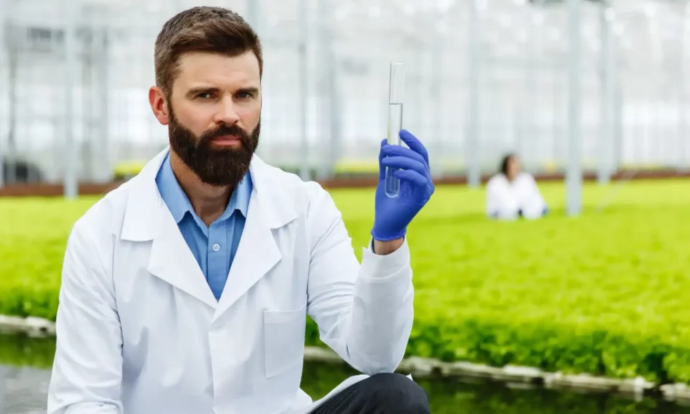 vecteezy_thoughtful-man-researcher-holds-a-glass-tube-with-sample_1486127 1